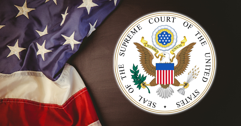 The seal of the Supreme Court of the United States next to a folded American flag.